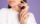 Beauty nail concept, petty woman with pink spring color manicure white sweater purple background