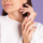 Beauty nail concept, petty woman with pink spring color manicure white sweater purple background